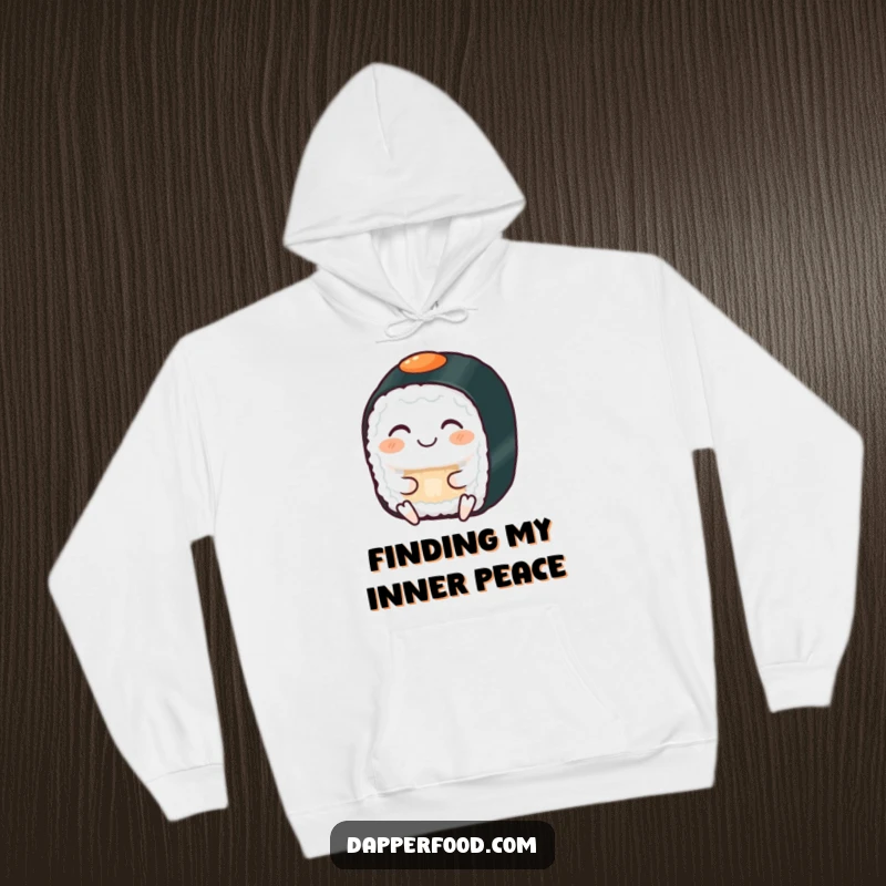Funny hoodie showing a grinning sushi roll with eyes closed, serenely meditating, offering warmth and calm humor.