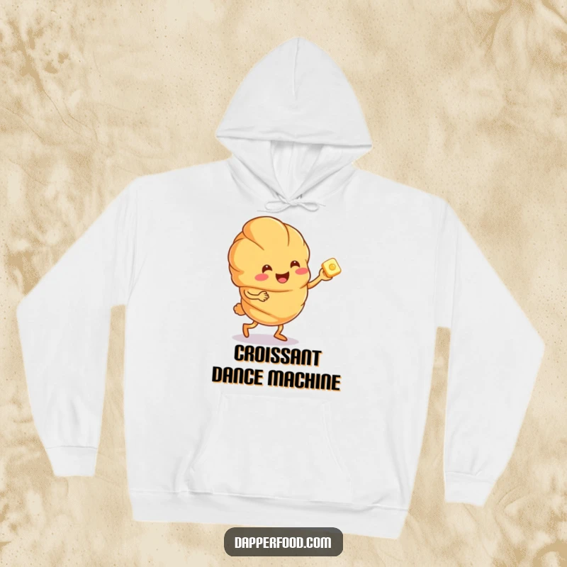 Funny anthropomorphic croissant character doing a joyful jig with a tiny butter pat, featured on a cozy hoodie.
