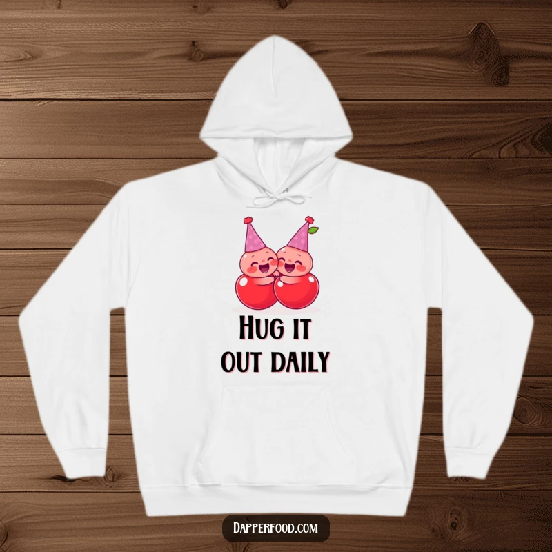 Funny giggling cherries wearing tiny party hats, sharing a joyful, exaggerated hug, on a comfortable and funny hoodie.