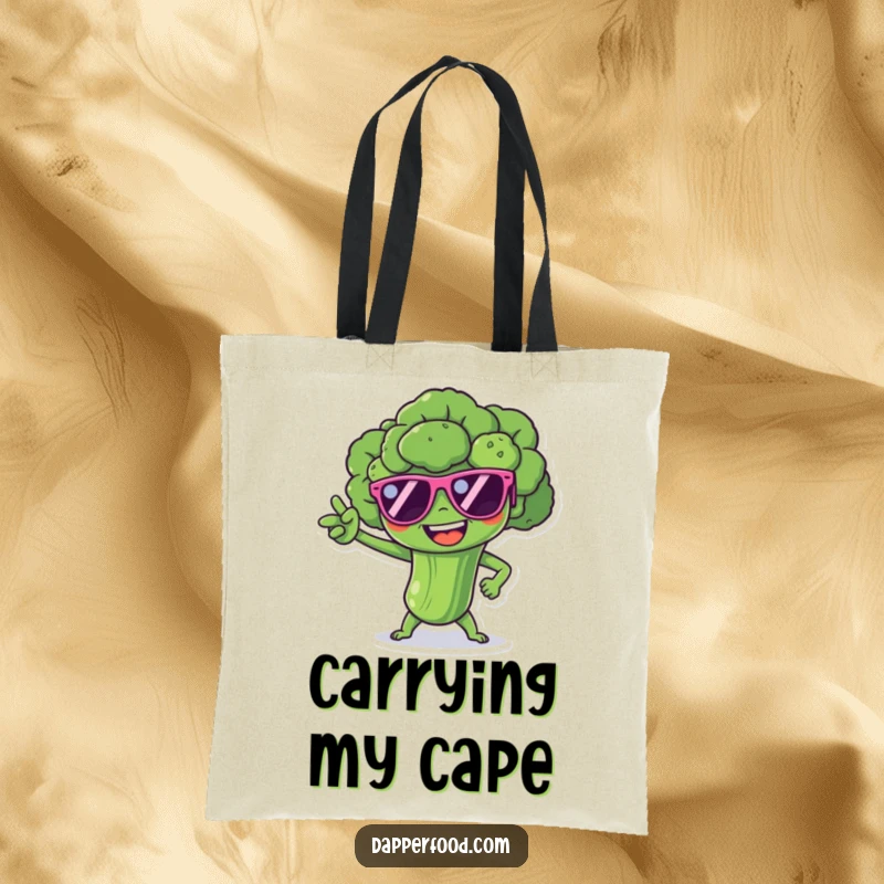 Funny broccoli spear character with tiny sunglasses, striking a superhero pose, on a humorous and practical tote bag.
